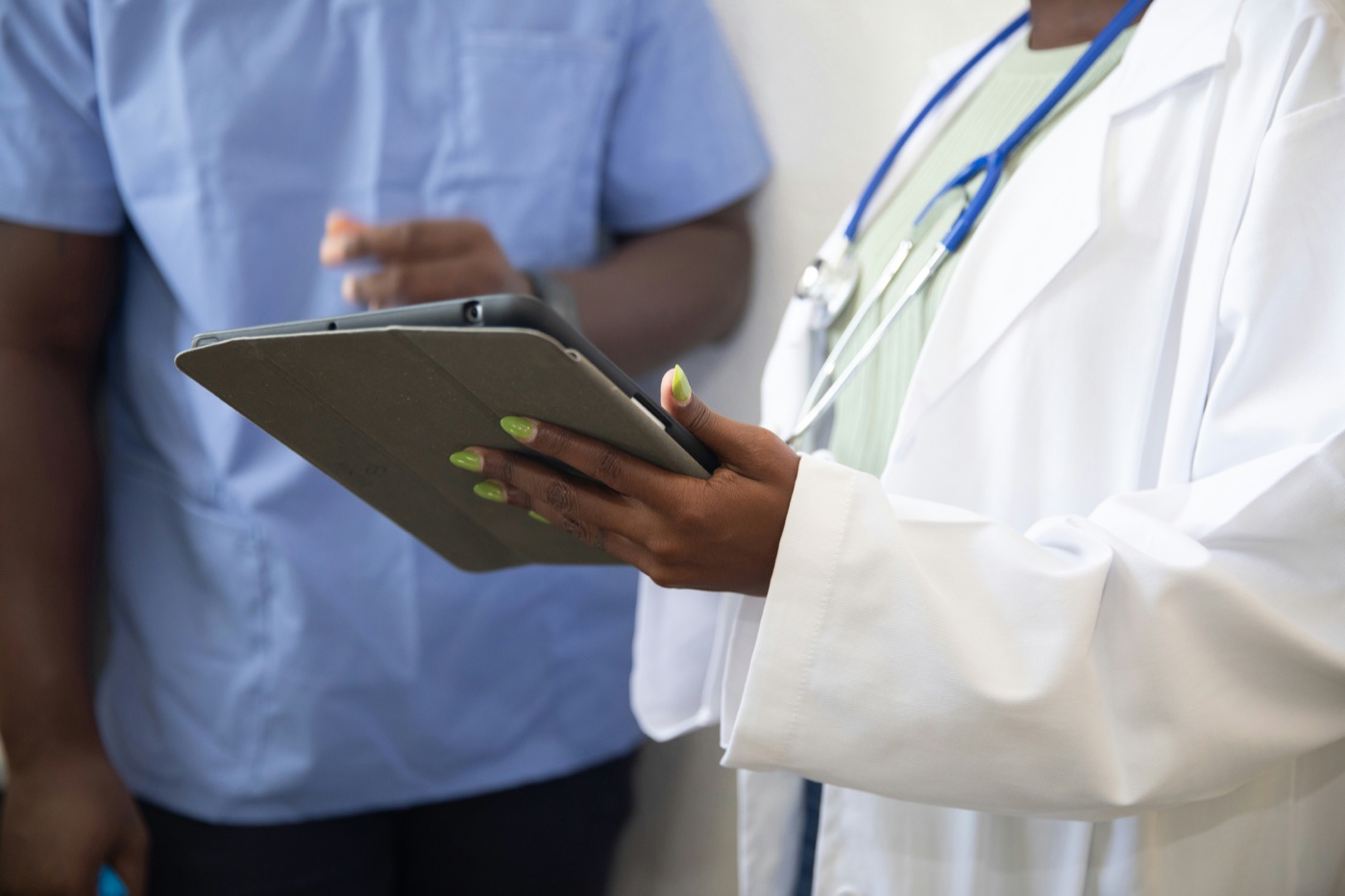 Doctor and nurse reviewing healthcare information on a tablet