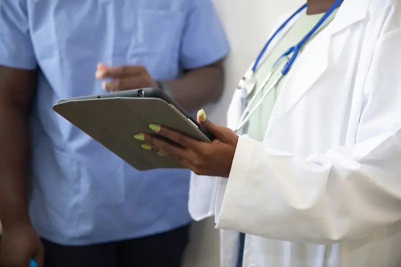 Doctor and nurse reviewing healthcare information on a tablet